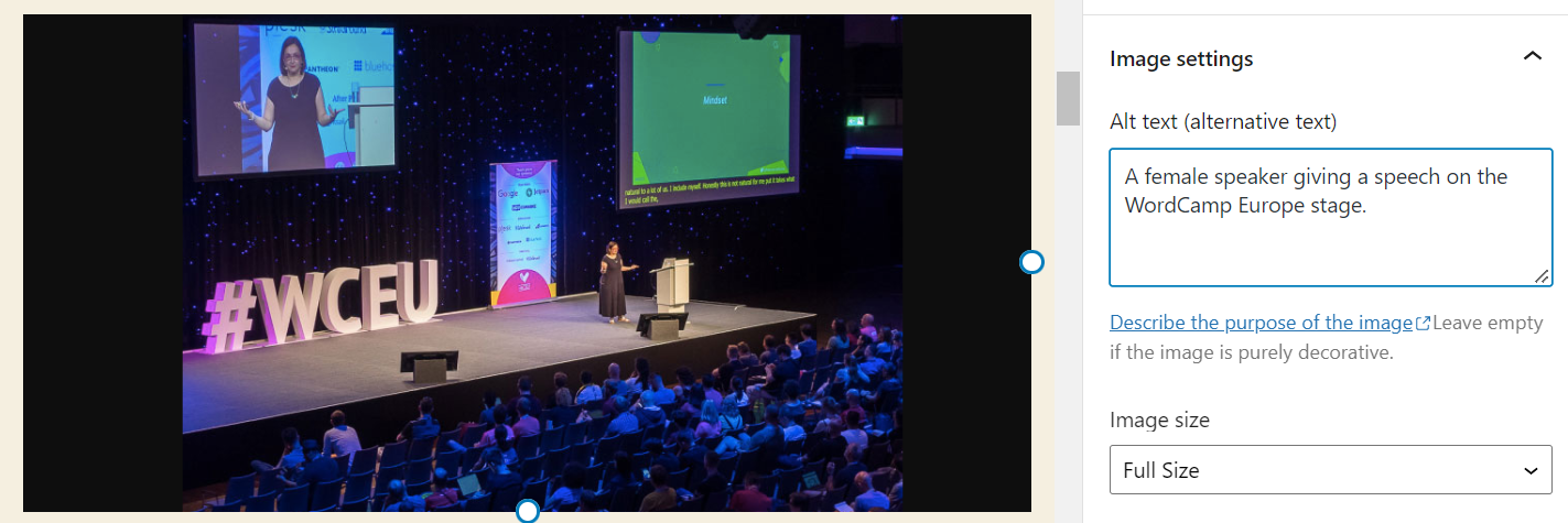 An example of image alt text where aa female speaker giving speech on the WordCamp Europe stage