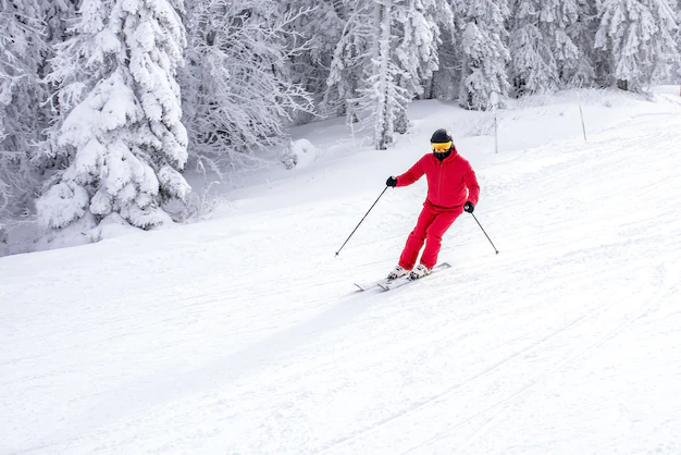 Man skiing down snow covered mountain
